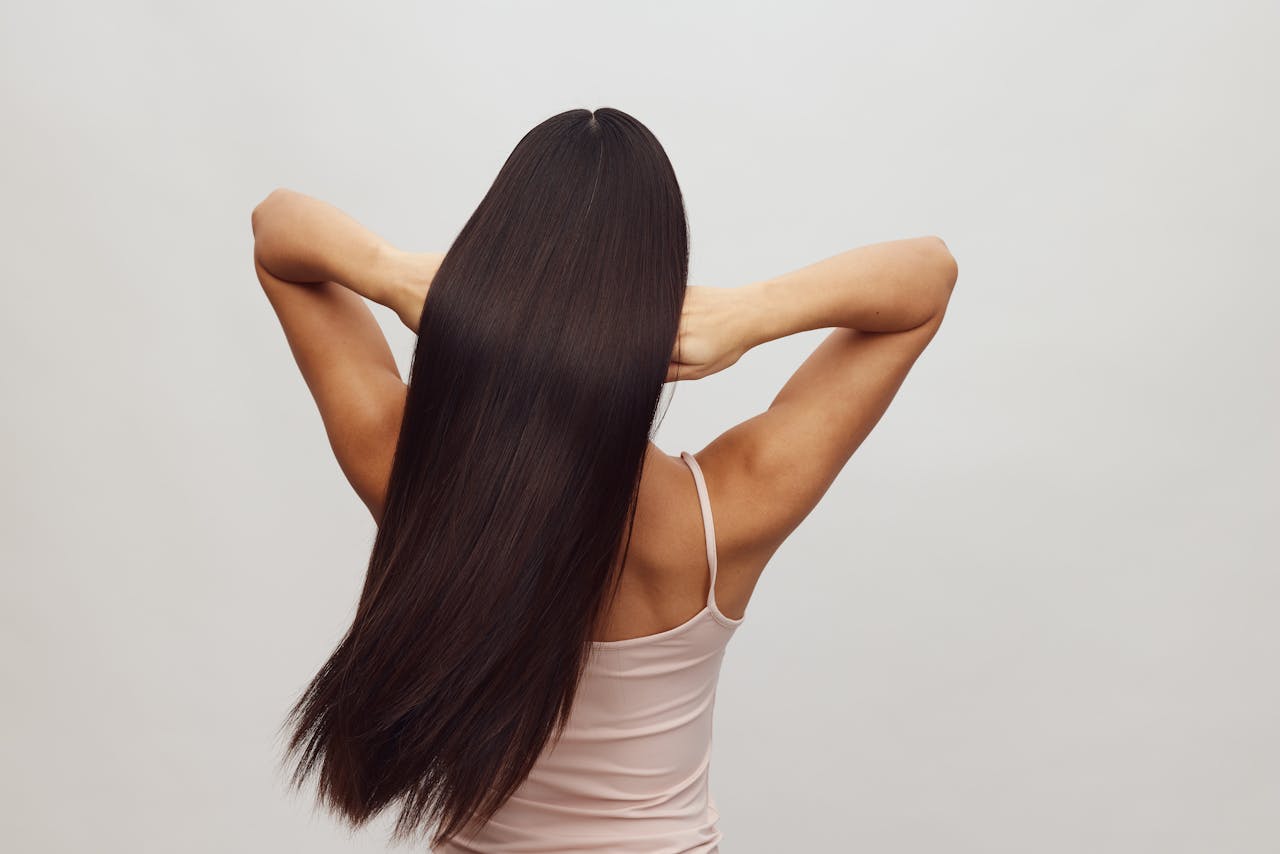 The Art of Drawing Readers In: Your attractive post title goes here Asian woman with long, straight hair shown from behind, embracing hair care and beauty.